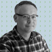 A man wearing glasses and a plaid shirt.