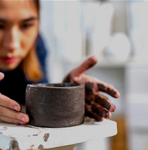 Woman sculpting pottery