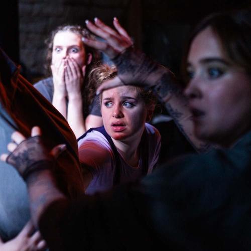 Group of students looking shocked on stage