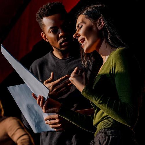 Acting students rehearsing their lines on stage
