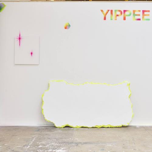 A student's exhibition at Locksbrook, with stark white walls and brightly coloured paint splotches
