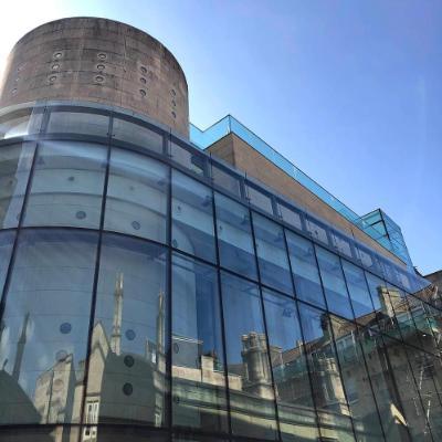 The Thermae Bath Spa building in Bath, with older buildings reflected in the glass