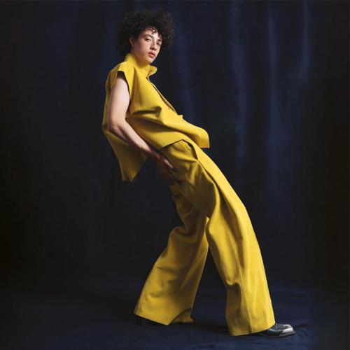 Person in yellow trouser suit on stage
