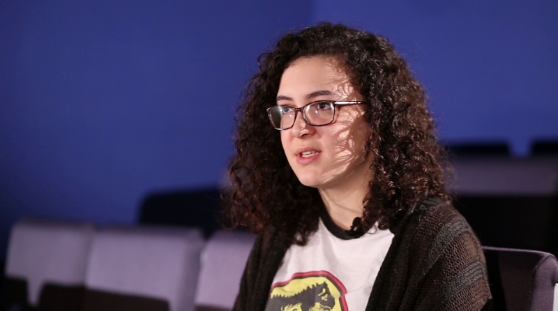 Student with cinema seating around her