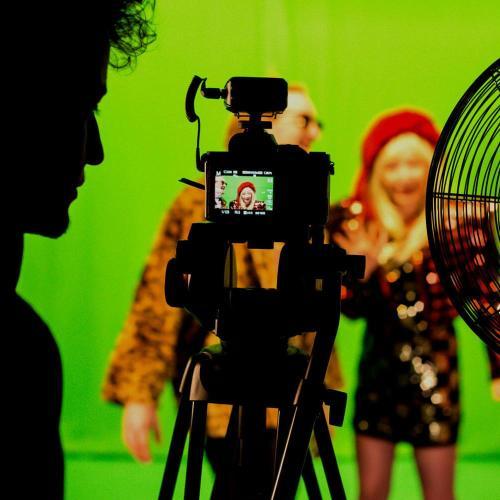 Students in front of and behind the camera