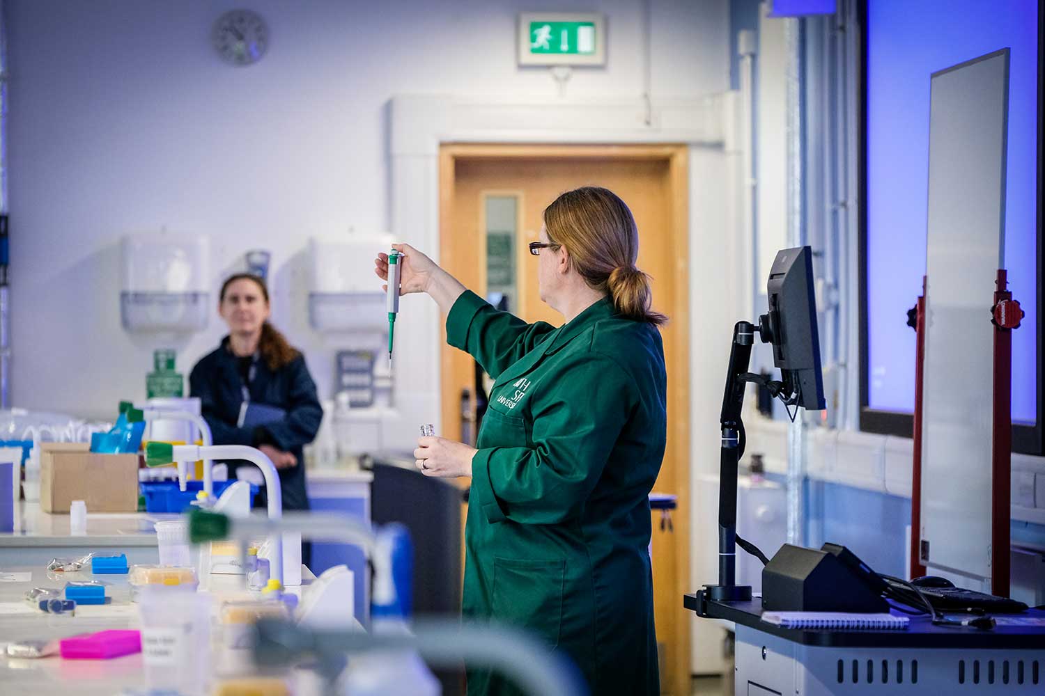 A science lecturer demonstrates an experiment to students