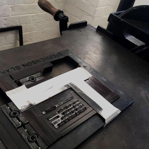 Old fashioned printing press and paper