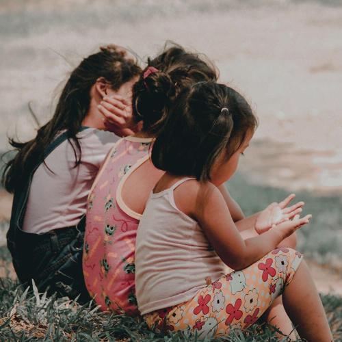 Children sitting together on grass