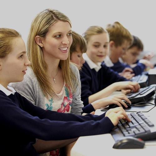 Teacher and pupil in computer class.