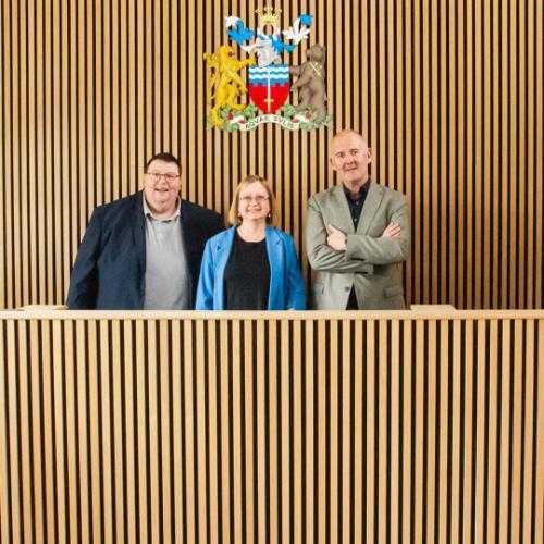 Course Leader Steve Goulton poses with VC Georgina Andrews and Sean McDonough from Mogers Drewett in BSU's mock courtroom