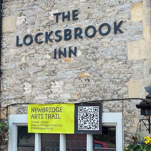 The exterior of a pub with a Newbridge Arts Trail sign