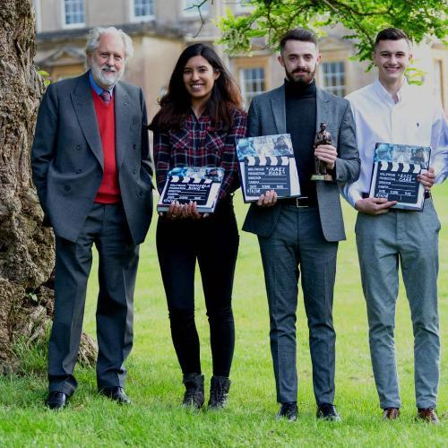 Students with Lord Puttnam, holding their awards