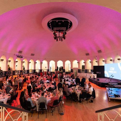 A group of people sitting under a domed roof at an awards show