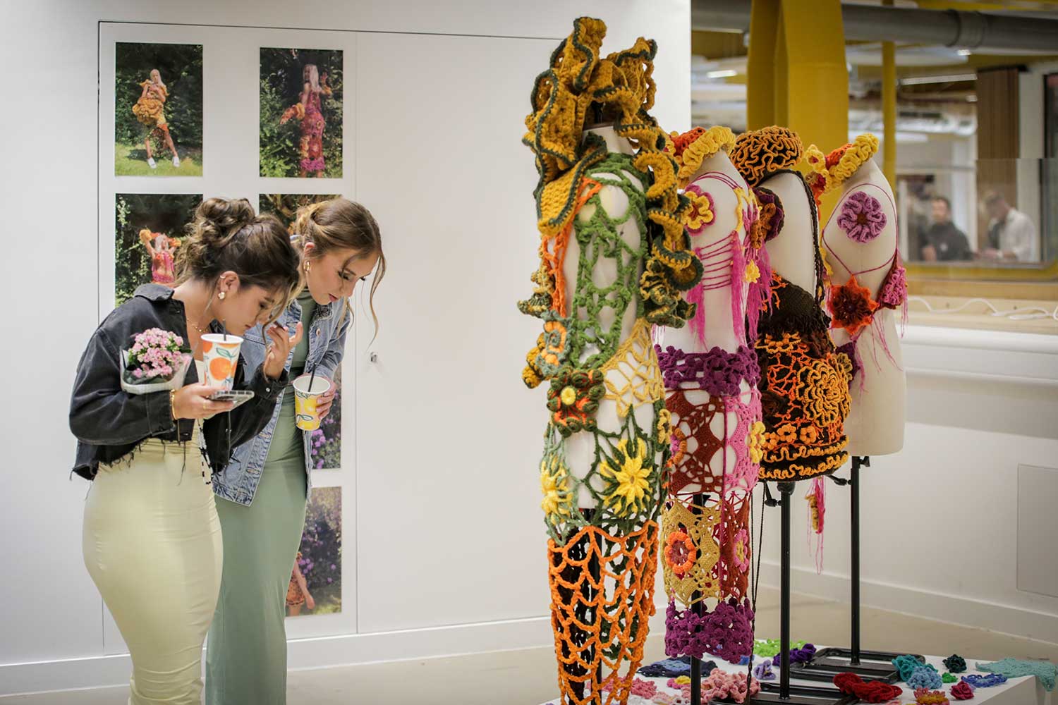 Two students look at textile work on display