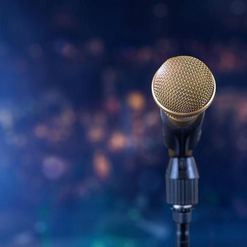 a close up of a microphone in a stand set up on a stage