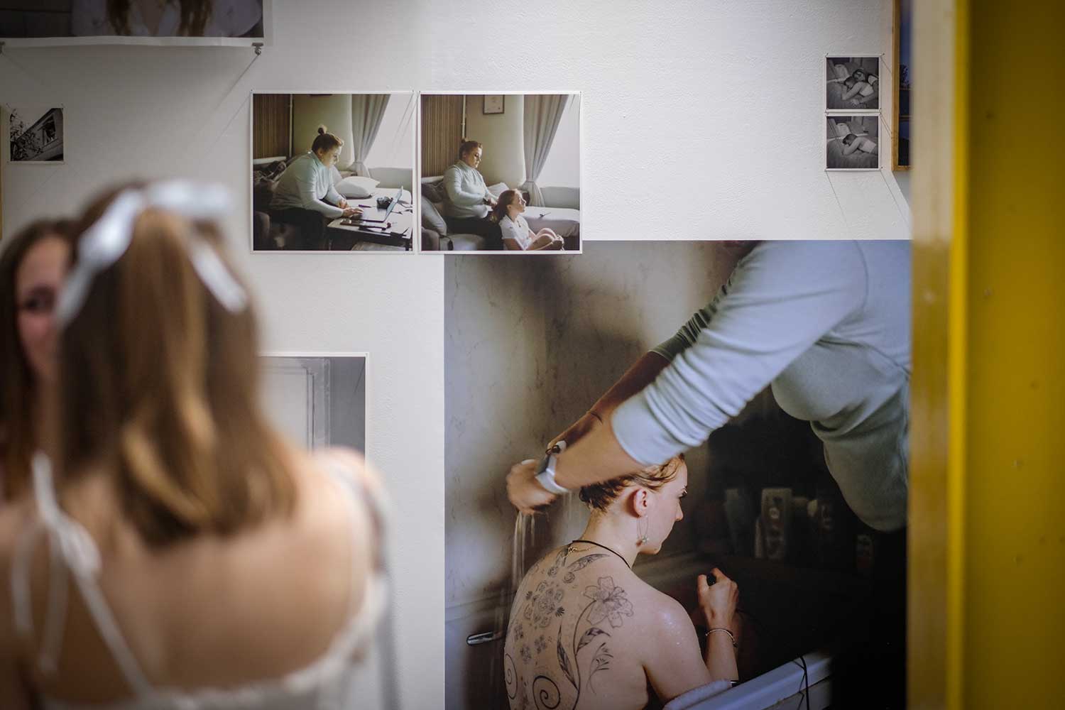 A photography exhibition with two students standing just out of frame