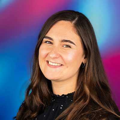 Headshot of someone with long dark hair smiling