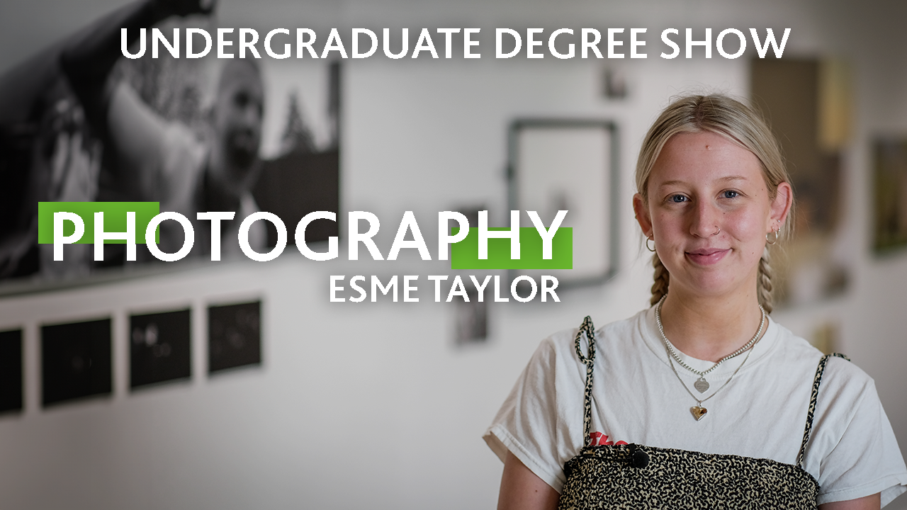 A person wearing a white t-shirt with text that reads: Esme Taylor, Photography, Undergraduate Degree Show