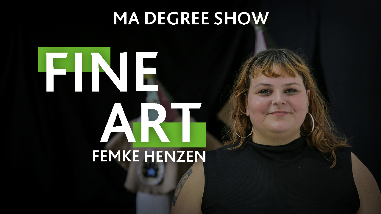A person wearing a black top with text that reads: Femke Henzen, Fine art, MA Degree Show
