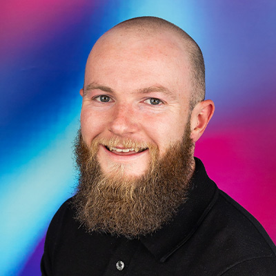 Person with short hair and long beard