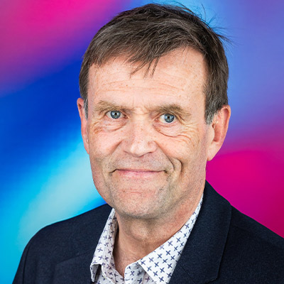 Headshot of someone in shirt and blazer with short hair